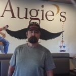 Man aligns with a painted mustache at one of the quirky restaurants in Prescott.