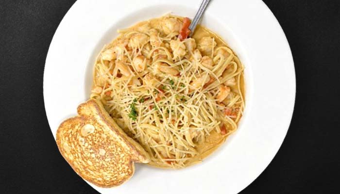 A plate of creamy pasta with shrimp from Augie’s, one of the top restaurants in Prescott.