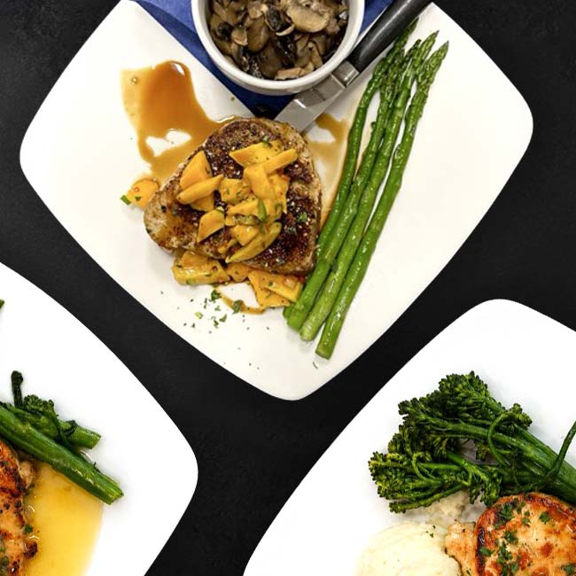 Three plates with grilled meats, asparagus, and mushrooms at Augie’s Outdoor Dining Prescott.